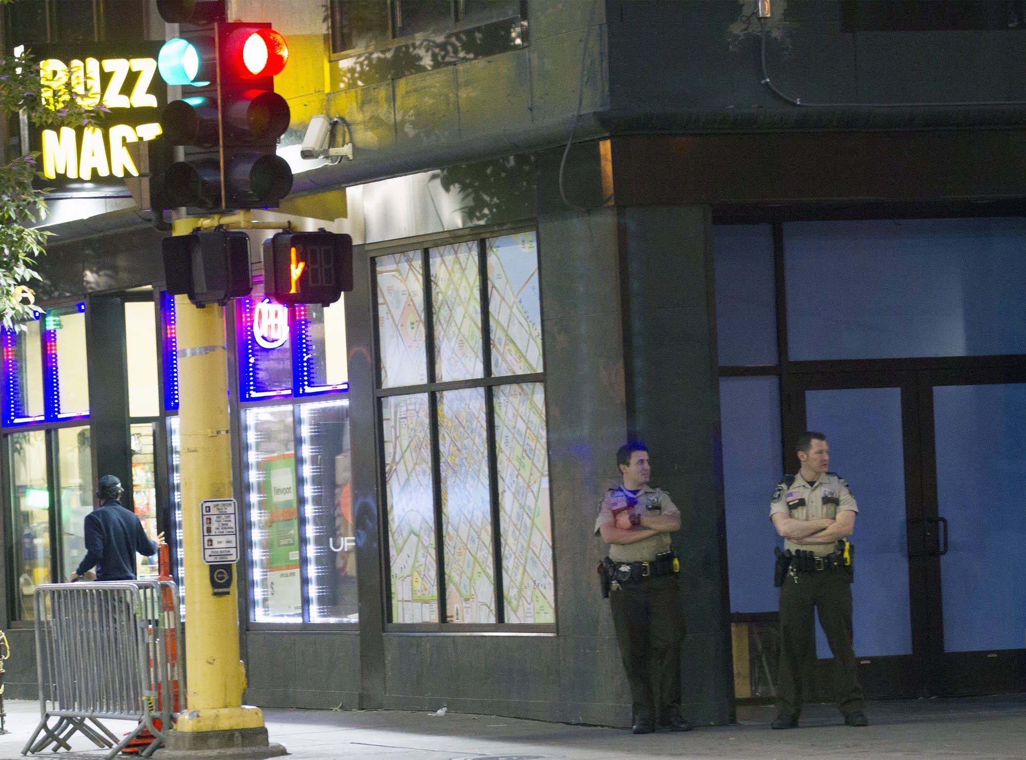 Officers watch the intersection of Hennepin Avenue and 5th St. No.