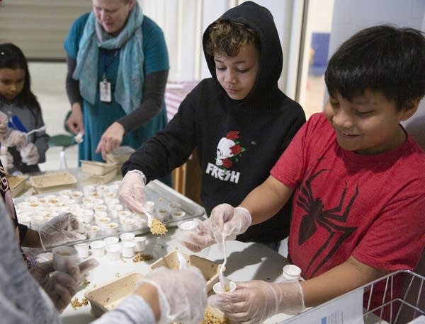 Joshua and Malik prepare samples of sunrise breakfast grain.