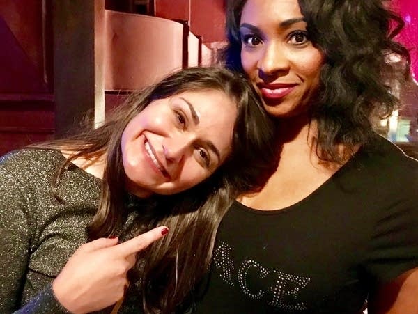 two women embrace each other for a photo