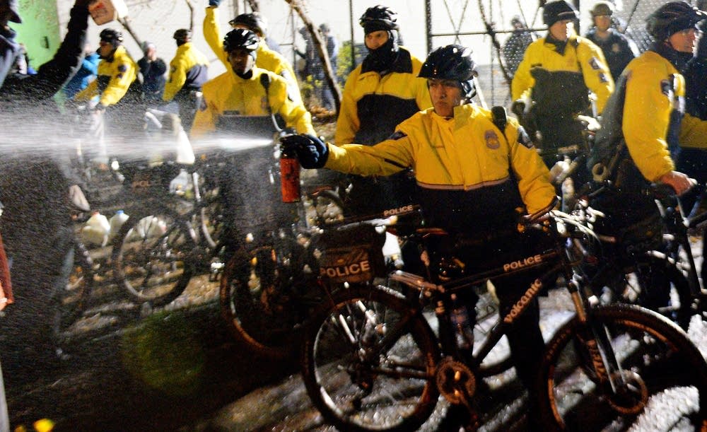 Police officer sprayed liquid.