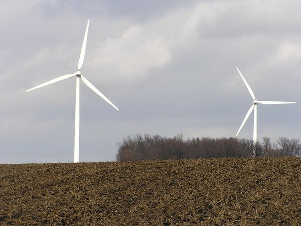 Wind turbines send electricity to an energy storage unit.