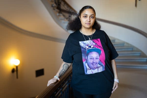 A woman poses in a stairwell