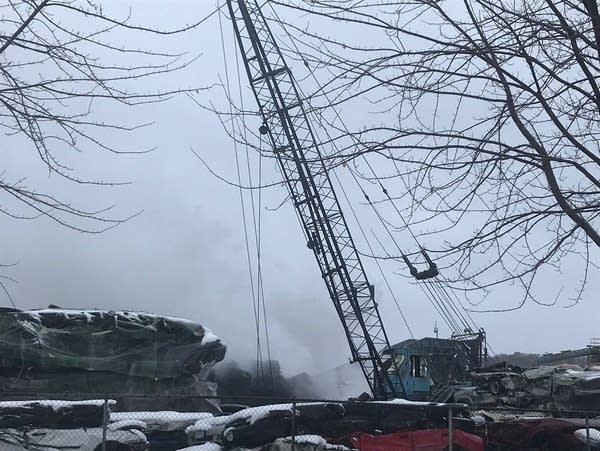 Smoke rises from a vehicle scrapyard 