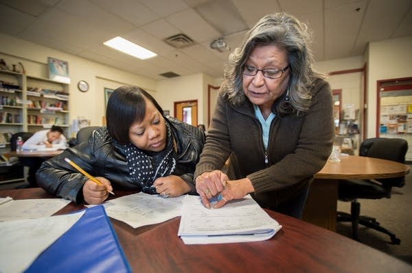 Darlene Barbour, right, helps Mykeisha Wright.