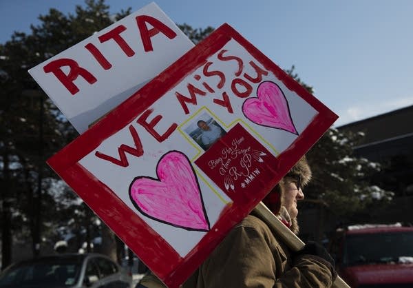 Thomas Peters of Tama, Iowa carries a sign honoring Rita Papakee.