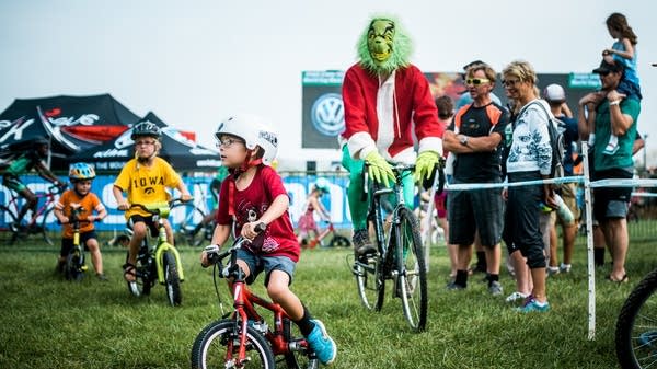 Alex Fortner, 5, rides with the Grinch.