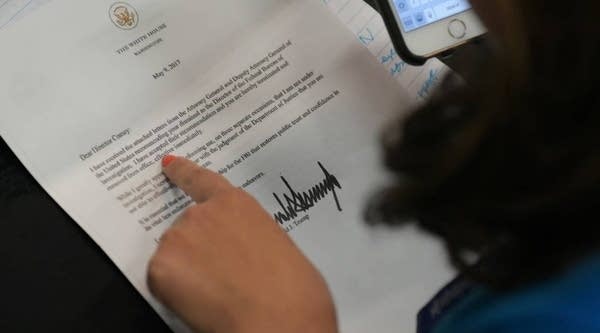A journalist looks at a copy of the termination letter to FBI Director James Comey from President Donald Trump on May 9, 2017. 