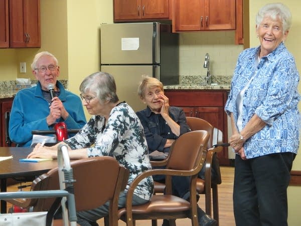 A resident asks a question during a meeting. 