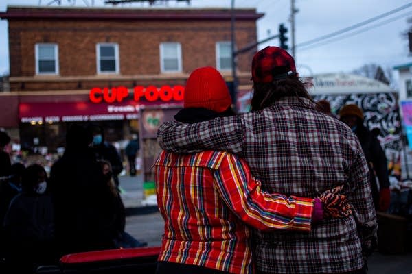 Two people hug each other.