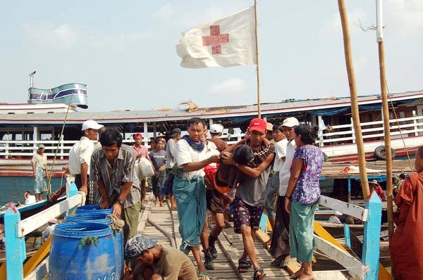 Locals assist an injured person