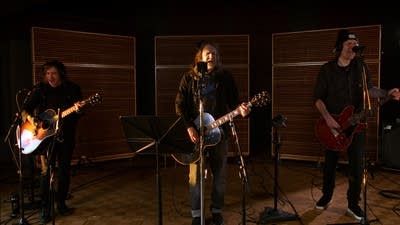 Three musicians performing in a recording studio