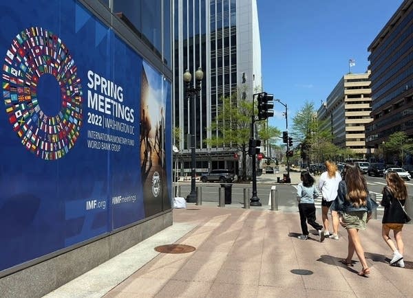 People walk past the International Monetary Fund (IMF), in Washington, DC, on April 17, 2022. The IMF and World Bank Group 2022 Sping Meeting will be held on April 18-24, 2022. (Photo by Daniel SLIM / AFP) (Photo by DANIEL SLIM/AFP via Getty Images)