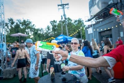 person using a watergun at an outdoor event