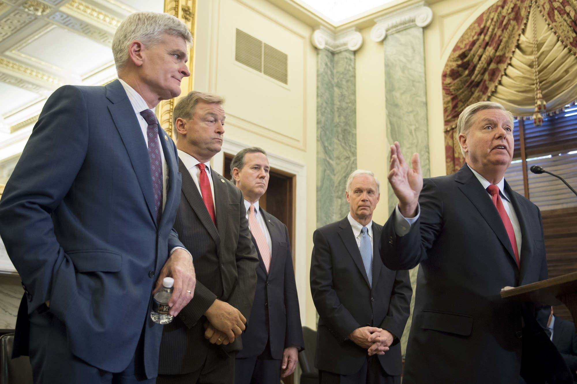 Sen. Lindsey Graham, right, R-S.C., stands with Sen. Bill Cassidy.
