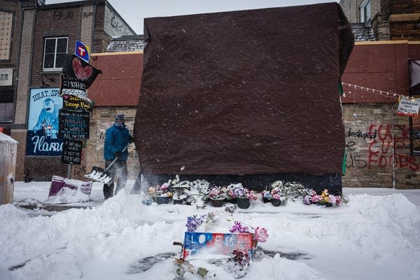 A man shovels a sidewalk