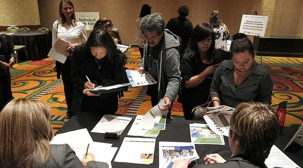 Job seekers talk with recruiters during a career fair. U.S. private payrolls picked up almost 300,000 jobs in February, which was far more than expected, according to an ADP report. More than 100,000 were in small businesses.