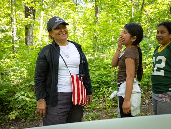 A woman laughing with students