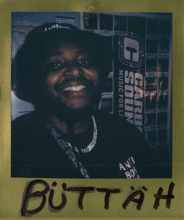 Man with bucket hat smiles in Polaroid photo