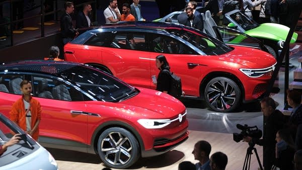 Visitors look at Volkswagen electric cars at the 2019 IAA Frankfurt auto show on Sept. 11 in Germany.