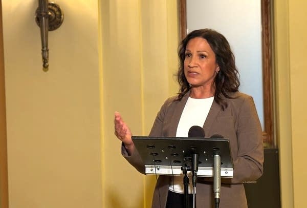 A woman speaks during a press conference