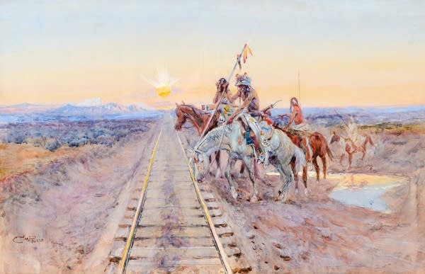 In this painting, t sunrise, a band of four Native American figures on horseback begin to cross railroad tracks. The tracks lead off into the distance, the sun directly overhead, in a beautiful, rose-colored desert and mountain scene.