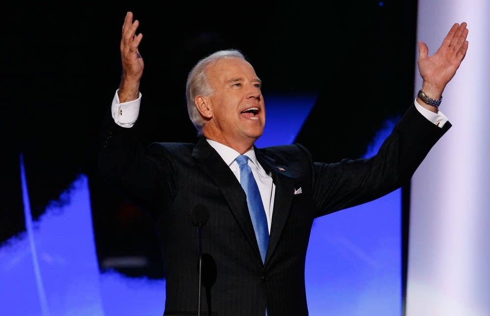 Joe Biden raises his arms at delegates at the DNC