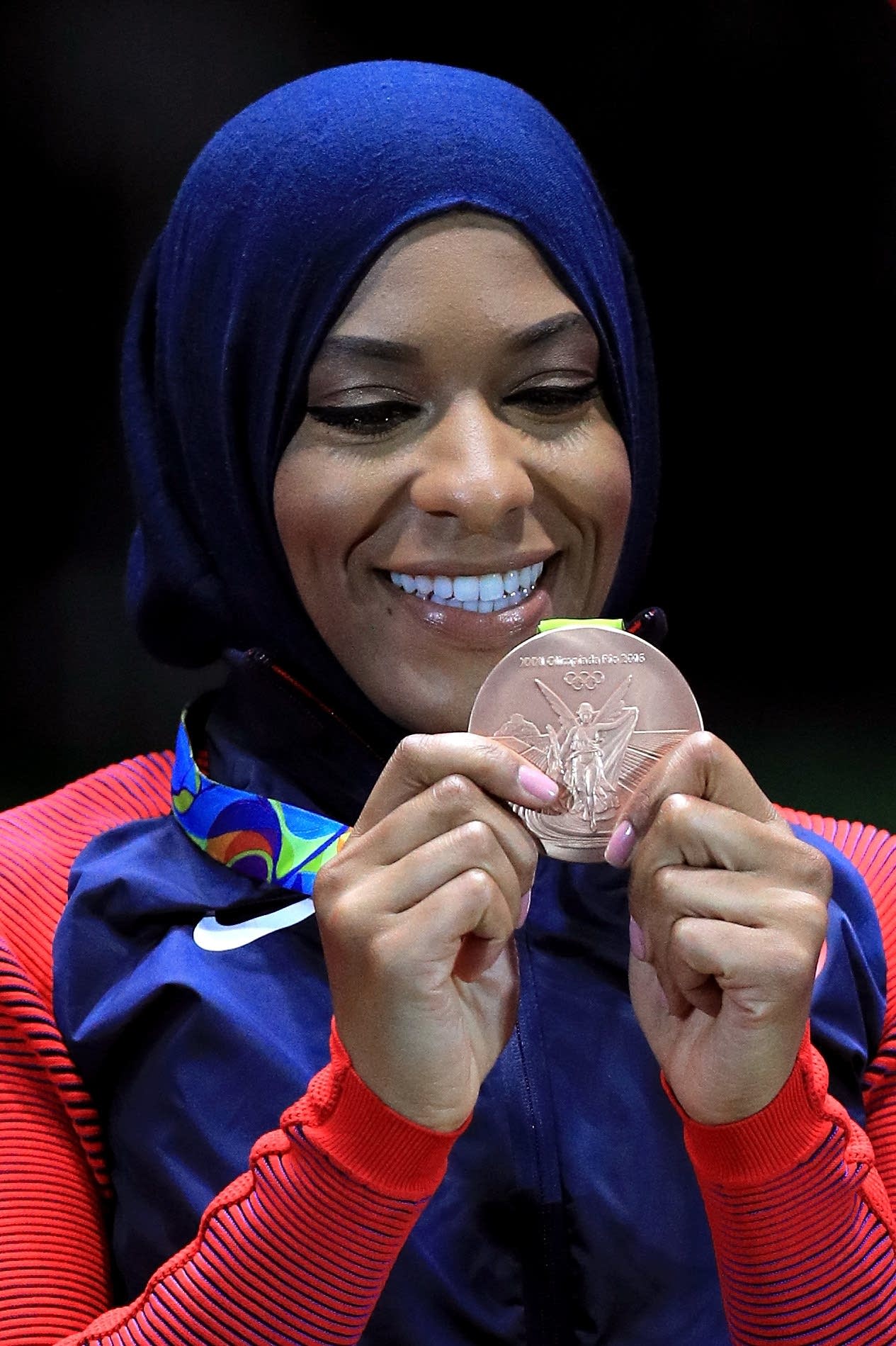 Bronze medalist Ibtihaj Muhammad of the United States celebrates.