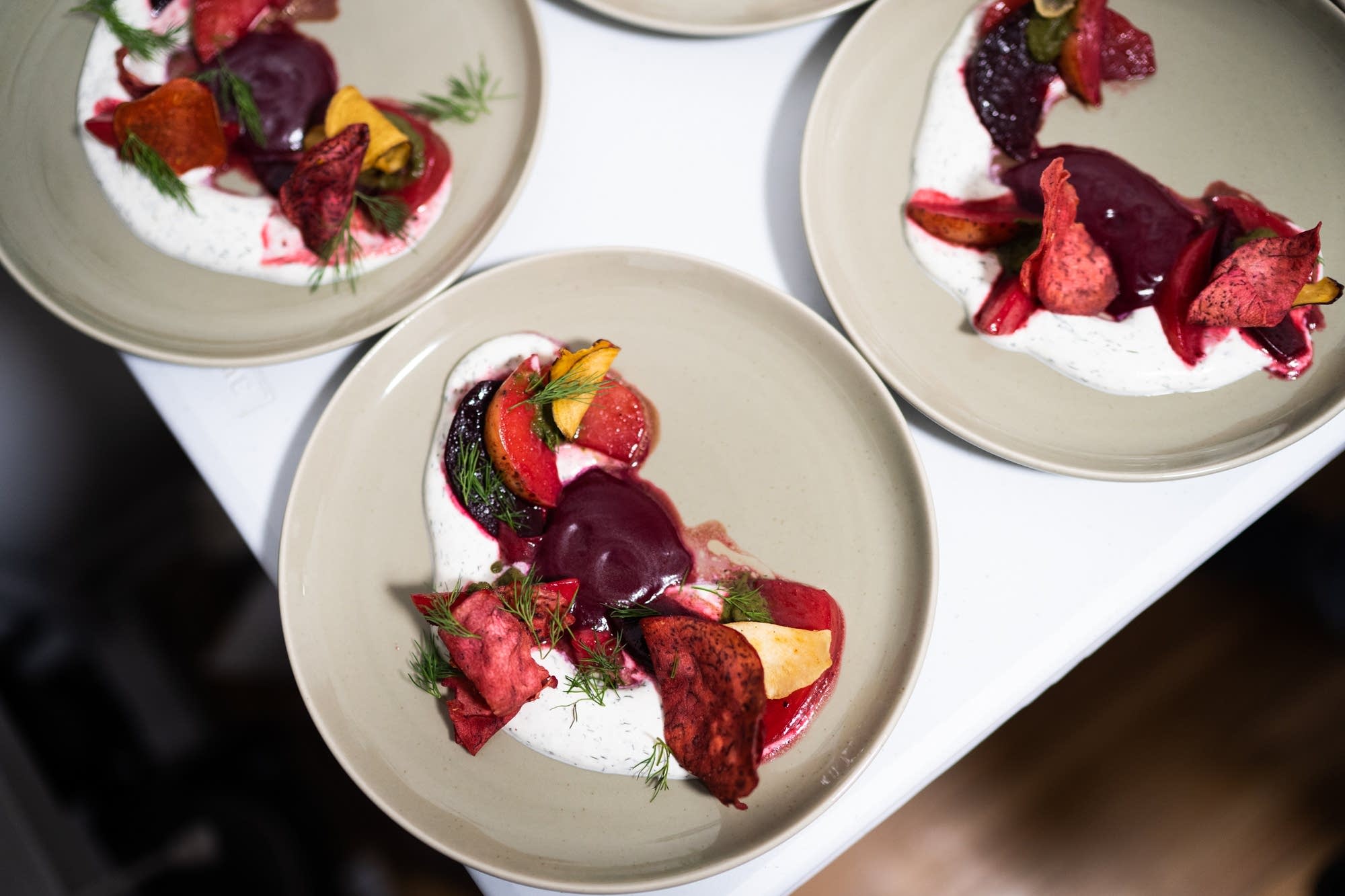 Roasted and fried root vegetables, dill sour cream, beet green puree.