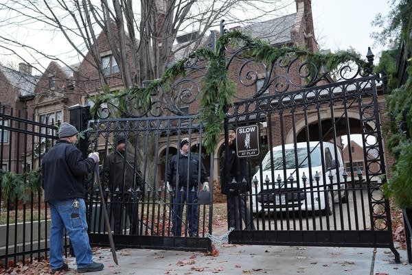 Police and maintenance workers assess damage to the gate.