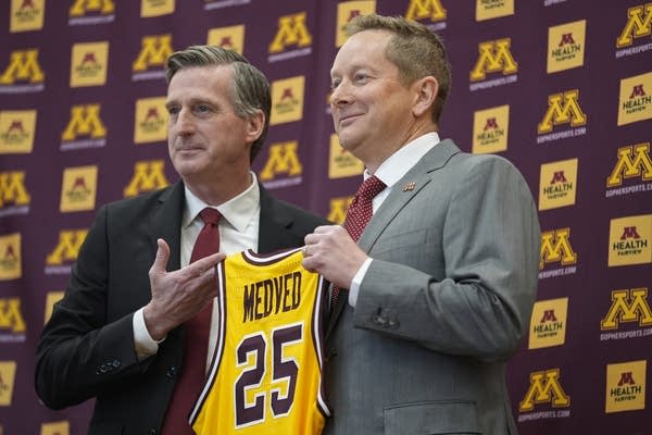 two men holding jersey