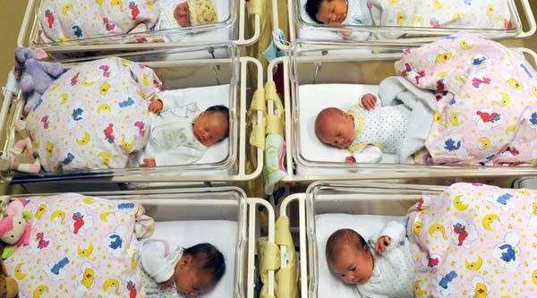 Newborn babies lay in their beds. 