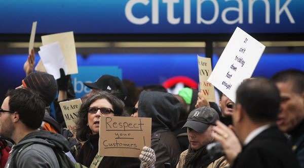 Protesters associated with Occupy Wall Street march past a Citibank branch in Manhattan on October 28, 2011 in New York City. Hundreds of protesters delivered 6,000 letters from angry bank customers to the headquarters of Bank of America, Morgan Stanley, Wells Fargo, Citigroup and JP Morgan Chase during the march.
