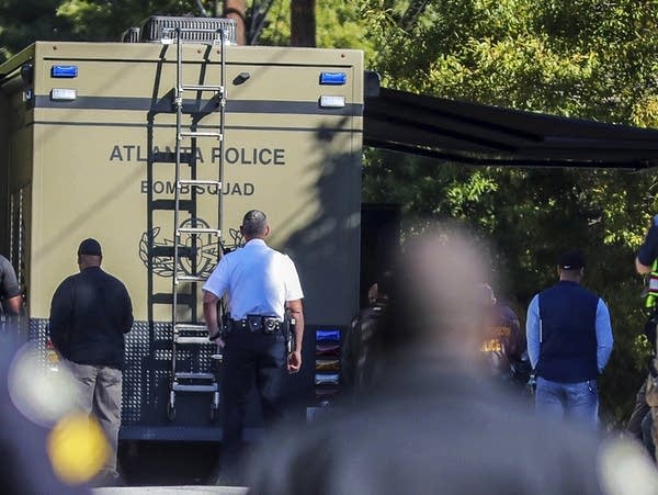 A bomb squad arrives with other authorities at a mail facility in Atlanta.
