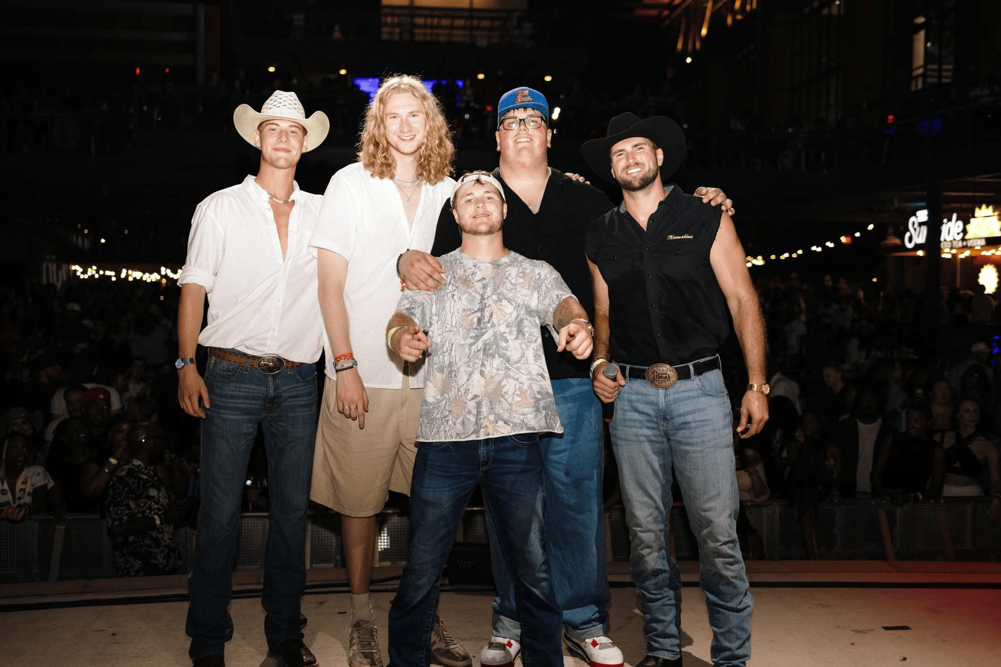 Men pose for photo onstage
