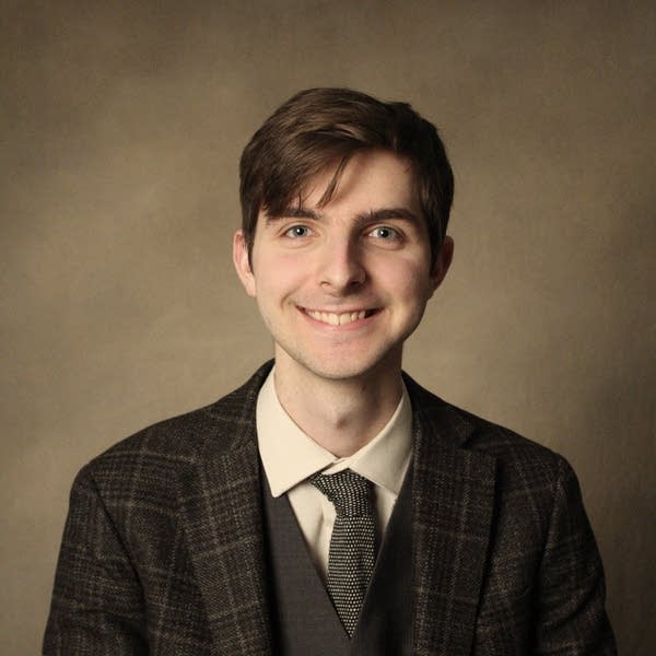 A man smiles for a photo