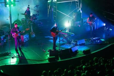 Alex G and band performing on stage