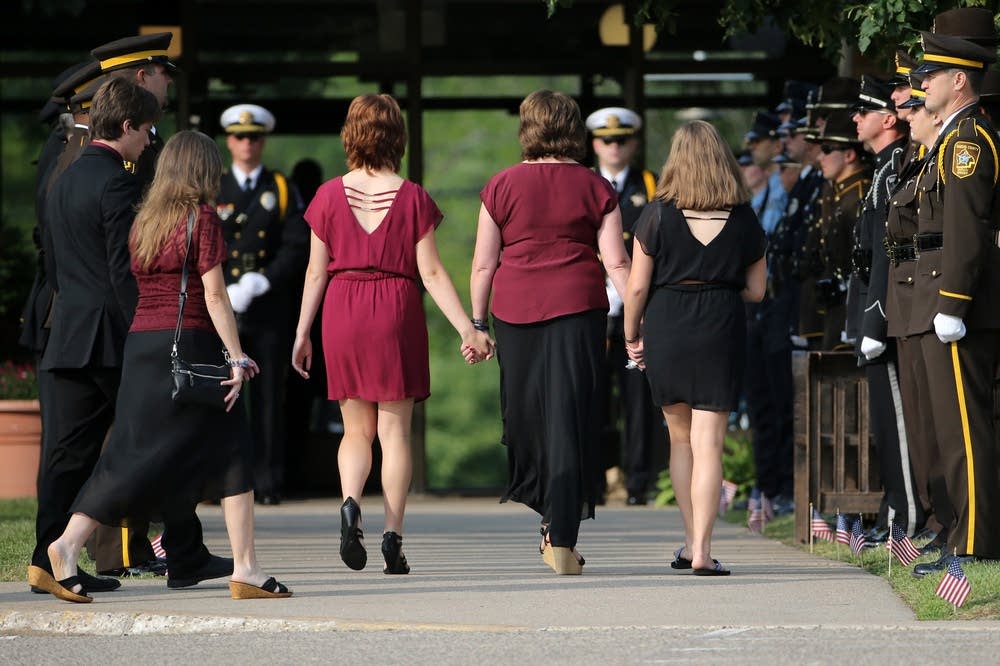The wife and daughters of Officer Patrick