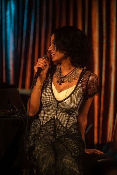 Woman holding microphone on stage