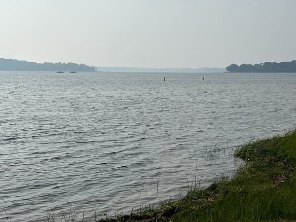 Lake with smoke hanging over it