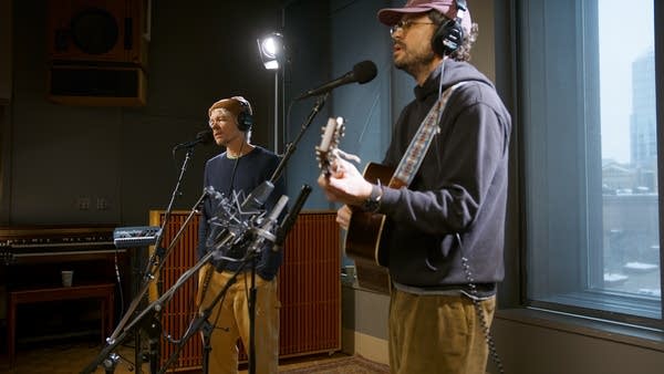 Two musicians performing in a recording studio