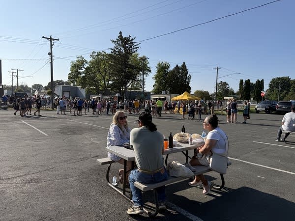 People sitting outside at a picnic table