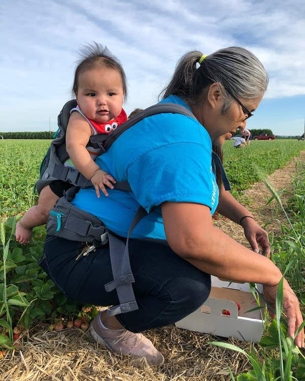 A woman with a baby on her back