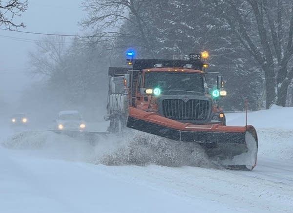 Vehicles traverse snowy roads