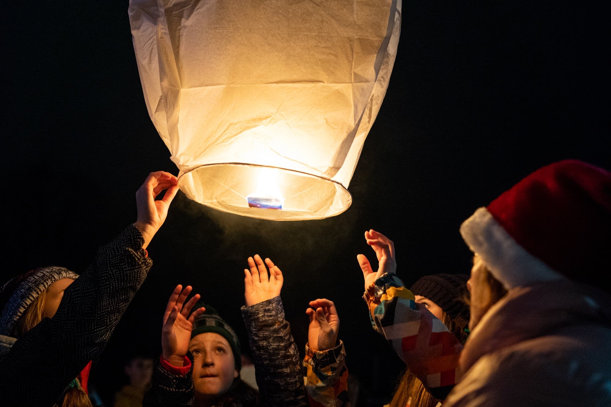 Barron middle school students release peace lanterns into the night sky.