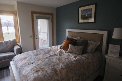 A bedroom for parents sits on display.