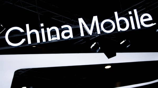 A logo sits illumintated outside the China Mobile booth on day 2 of the GSMA Mobile World Congress 2019 on February 26, 2019 in Barcelona, Spain.