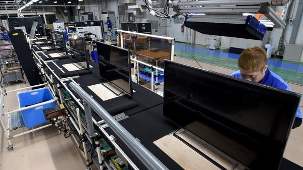 LCD 4K TVs sit on an assembly line at a factory in Japan. Some movie buffs prefer older plasma TVs.