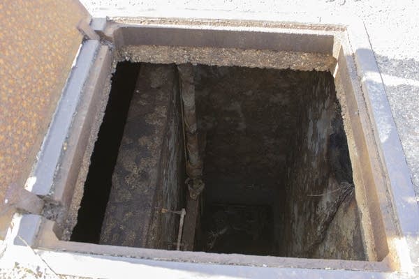 A look into a maintenance hatch in the ground. 