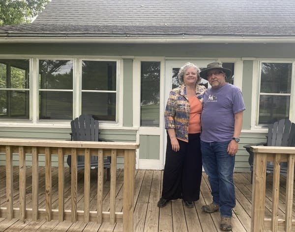 Beverly Jones and Paul Seaman stand on the front porch of one of their Airbnb properties in Tarkio, Missouri. 