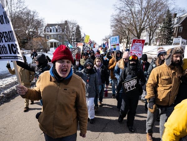 People take part in a march down a city street